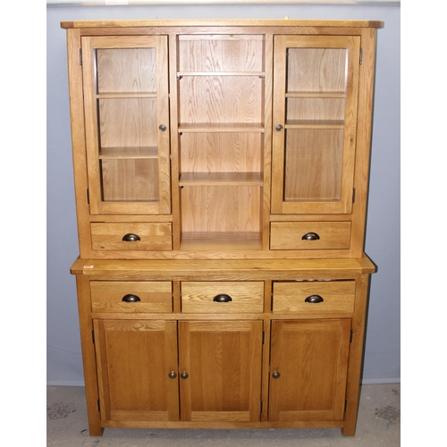 30 - A large modern light oak dresser with sideboard base and glazed cupboard tops, likely from Oak Furni... 