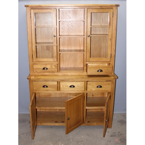 30 - A large modern light oak dresser with sideboard base and glazed cupboard tops, likely from Oak Furni... 