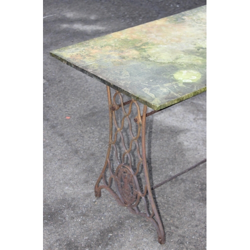 312 - A vintage marble topped garden table with cast iron Singer sewing machine base, approx 113cm wide x ... 