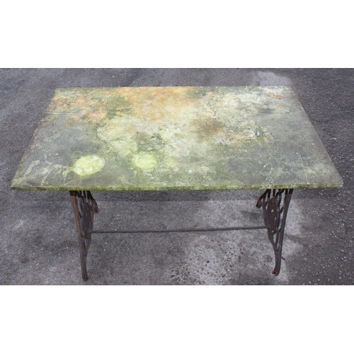 312 - A vintage marble topped garden table with cast iron Singer sewing machine base, approx 113cm wide x ... 