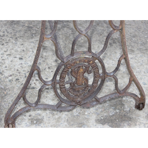 312 - A vintage marble topped garden table with cast iron Singer sewing machine base, approx 113cm wide x ... 