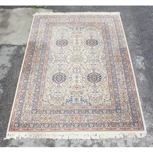 229D - A decorative Keshan style rug of cream ground with decorative motifs, approx 300cm x 200cm