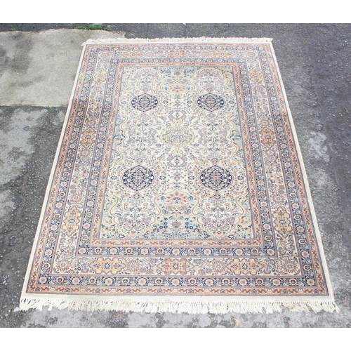 229D - A decorative Keshan style rug of cream ground with decorative motifs, approx 300cm x 200cm