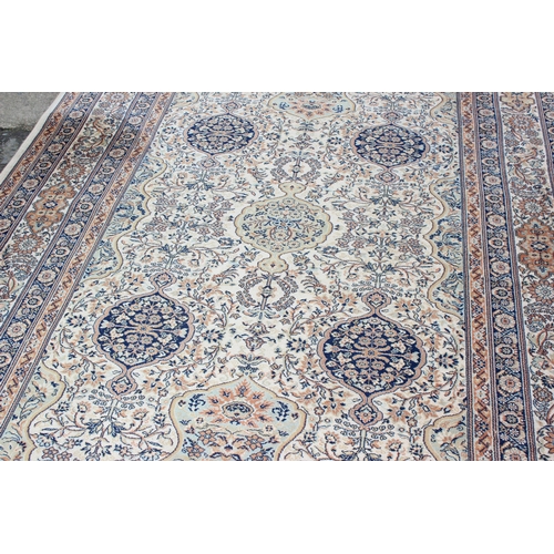 229D - A decorative Keshan style rug of cream ground with decorative motifs, approx 300cm x 200cm