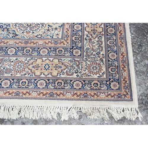 229D - A decorative Keshan style rug of cream ground with decorative motifs, approx 300cm x 200cm