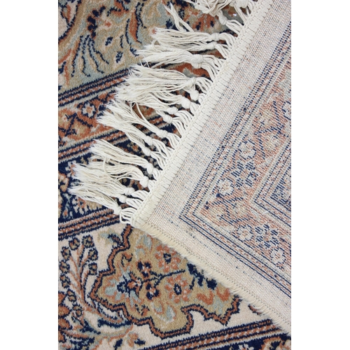 229D - A decorative Keshan style rug of cream ground with decorative motifs, approx 300cm x 200cm