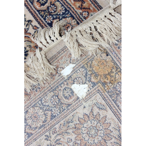 229D - A decorative Keshan style rug of cream ground with decorative motifs, approx 300cm x 200cm