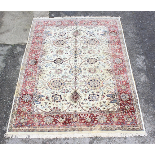 229C - A highly decorative handmade Keshan style rug with cream ground and red border, approx 270cm x 187cm