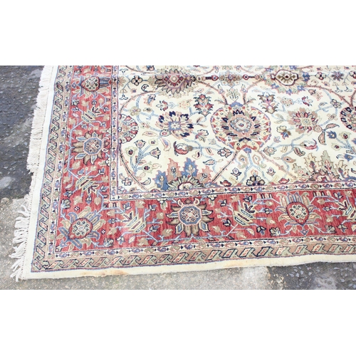 229C - A highly decorative handmade Keshan style rug with cream ground and red border, approx 270cm x 187cm