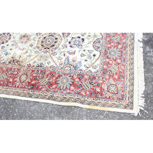 229C - A highly decorative handmade Keshan style rug with cream ground and red border, approx 270cm x 187cm