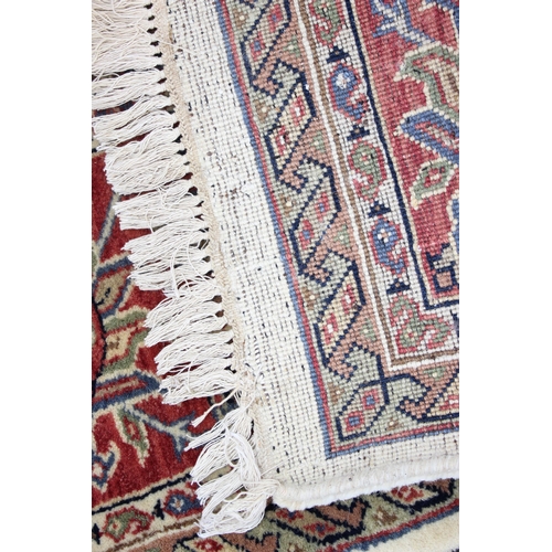 229C - A highly decorative handmade Keshan style rug with cream ground and red border, approx 270cm x 187cm