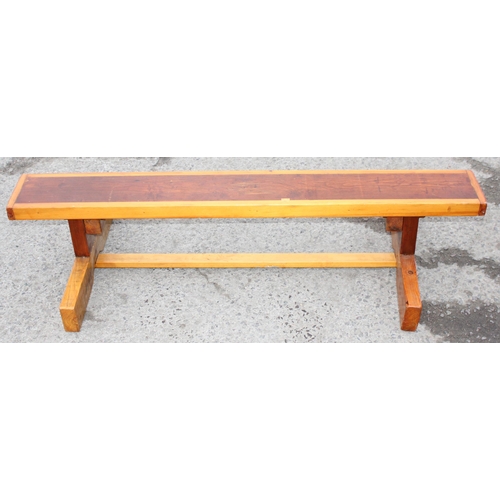 64 - A low stained pine bench, school gym style, approx 134cm wide x 60cm deep x 30cm tall