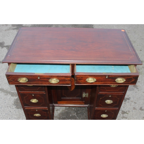 26 - A 19th century mahogany and Sheraton style satinwood inlaid kneehole desk with 8 drawers and a cupbo... 