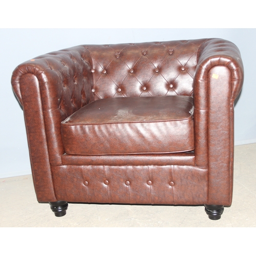 86 - An antique style Chesterfield buttonback club or tub chair, brown faux leather, approx 100cm wide x ... 