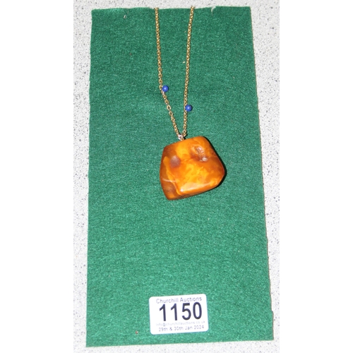 1150 - Large piece of raw amber on gold-plated chain, amber measures approx 4.5cm W x 1.5cm D x 4cm H, 30g ... 