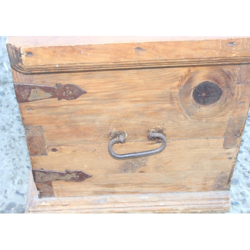 12 - A vintage wooden trunk with antique hand wrought ironwork fittings, approx 100cm wide x 42cm deep x ... 
