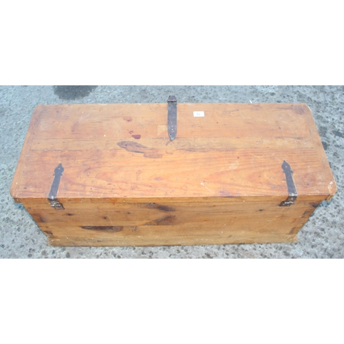 12 - A vintage wooden trunk with antique hand wrought ironwork fittings, approx 100cm wide x 42cm deep x ... 