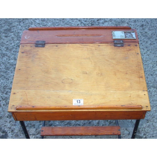 13 - A vintage wooden school desk with iron legs, approx 53cm wide x 43cm deep x 70cm tall