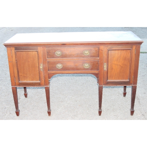 131 - An antique mahogany sideboard with 2 drawers flanked by 2 cupboards on spade legs, approx 152cm wide... 