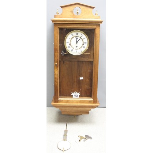 1320 - Light mahogany cased Vienna wall clock with brass finials, pendulum and key, approx 80cm