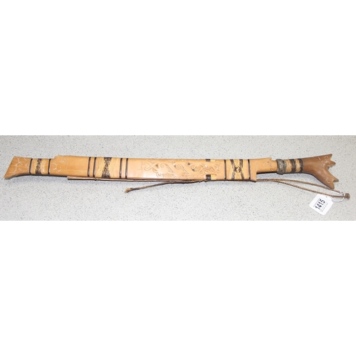 1415 - A vintage Dayak Mandau style sword with carved wooden sheath