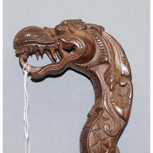 1611 - A Chinese carved hardwood walking stick formed a dragon, approx 98cm long