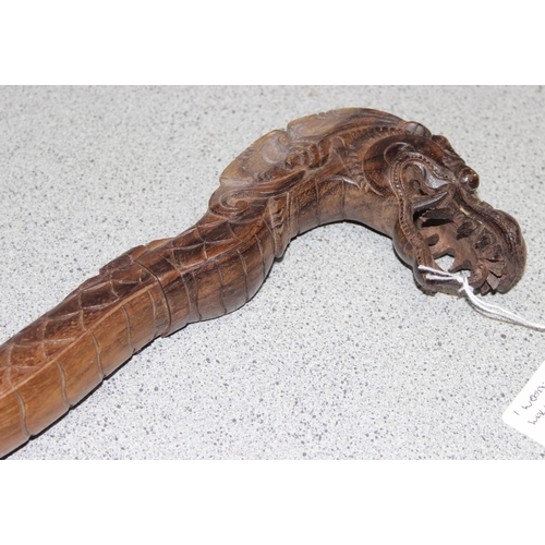 1611 - A Chinese carved hardwood walking stick formed a dragon, approx 98cm long