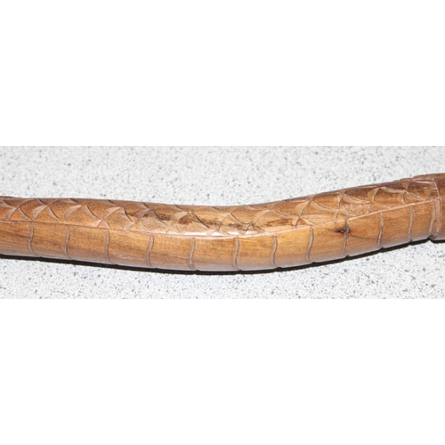 1611 - A Chinese carved hardwood walking stick formed a dragon, approx 98cm long