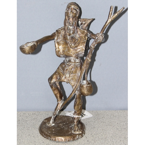 1657 - An unusual decorative African bronze figure of a male figure with stick and bowl, approx 26cm tall