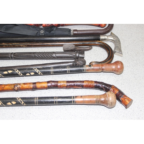 1708 - 9 x walking sticks, some with carved and painted details, and an umbrella (10)