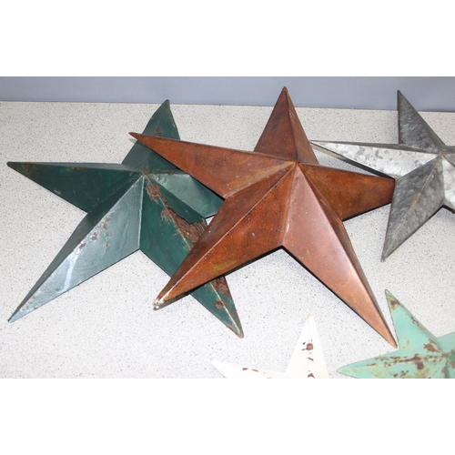 1734 - Collection of 7 vintage painted Amish barn tinware stars of varying sizes