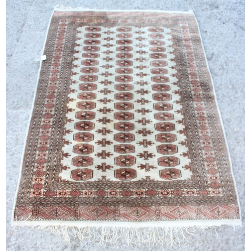 201 - An Afghan Turkmen style rug of cream ground, approx 190cm x 129cm