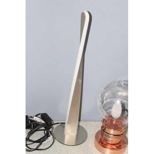 238 - Copper metal base and glass shaded novelty “lightbulb” table lamp with black braided lead, approx 27... 