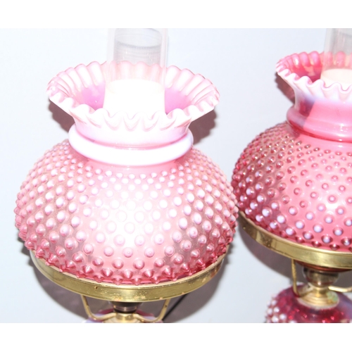 241 - Pair of Victorian cranberry hobnail opalescent glass and brass gas lamps mounted on white marble bas... 