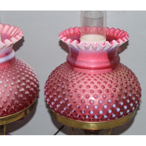 241 - Pair of Victorian cranberry hobnail opalescent glass and brass gas lamps mounted on white marble bas... 