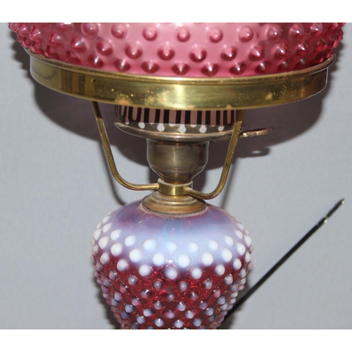 241 - Pair of Victorian cranberry hobnail opalescent glass and brass gas lamps mounted on white marble bas... 