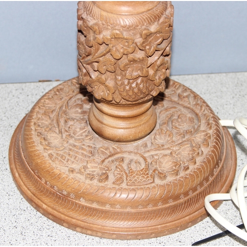 246 - Table lamp with carved foliage design wooden base and cream shade, approx 65cm H