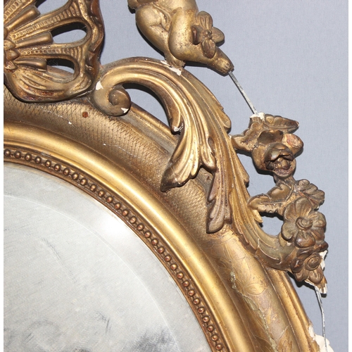 402 - A 19th century gilt framed oval mirror with carved wooden and gesso frame, approx 84cm x 52cm