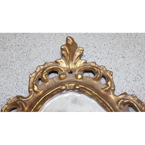 423 - 2 small ornate gilt-framed shaped mirrors, largest 38cm x 24cm