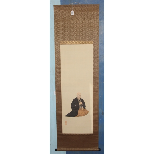 438 - Large Oriental scroll depicting a seated monk, hand painted on fabric, approx 180cm x 56cm