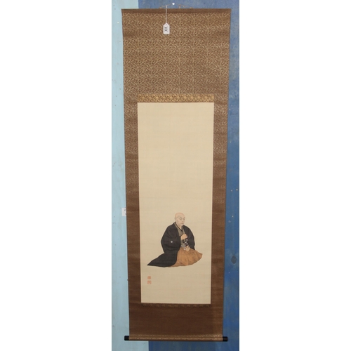 438 - Large Oriental scroll depicting a seated monk, hand painted on fabric, approx 180cm x 56cm