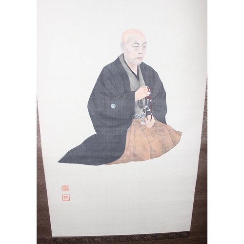 438 - Large Oriental scroll depicting a seated monk, hand painted on fabric, approx 180cm x 56cm