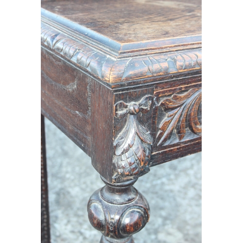 6 - A Jacobean Revival Green Man carved oak console or hall table, with singular sliding drawer carved w... 