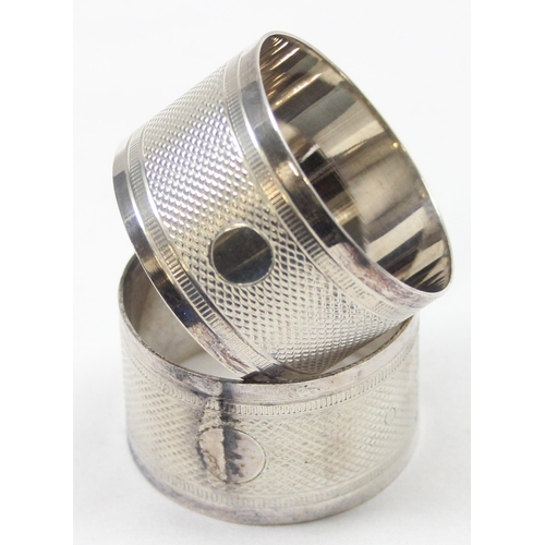 1024 - A pair of antique silver plated napkin rings in original leather case, each engraved with belt buckl... 