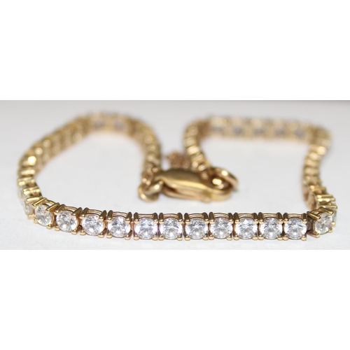 1142 - 9ct gold and white stone tennis bracelet, marked 375 & XRF confirmed, approx 20cm long, approx 9.21g... 