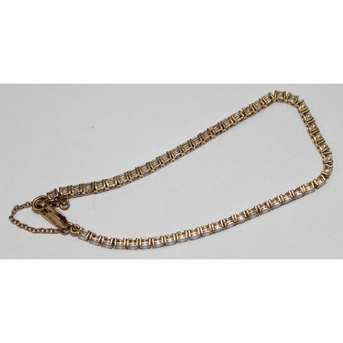 1142 - 9ct gold and white stone tennis bracelet, marked 375 & XRF confirmed, approx 20cm long, approx 9.21g... 