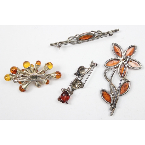 1163 - 4 silver and amber brooches of various designs, all XRF confirmed