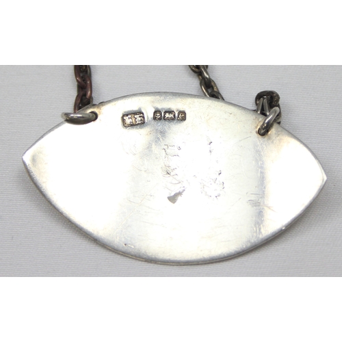 1039 - An Edwardian silver decanter label of leaf shaped form 