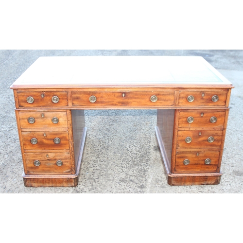 147 - A Victorian mahogany pedestal desk with green tooled leather top and brass ring handles, approx 138c... 