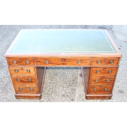 147 - A Victorian mahogany pedestal desk with green tooled leather top and brass ring handles, approx 138c... 